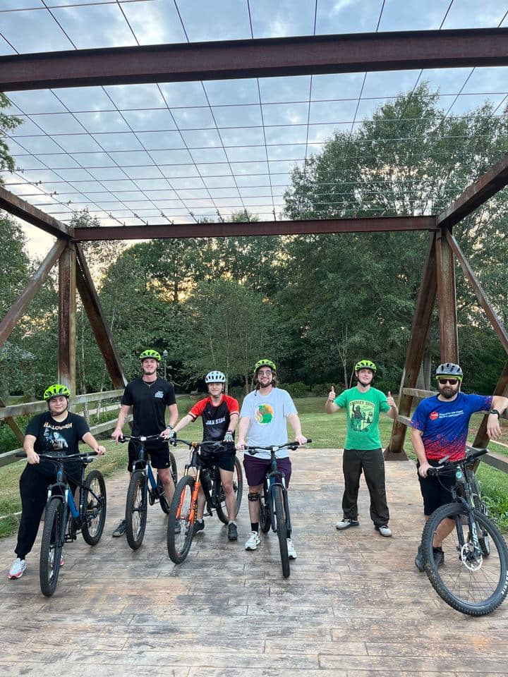 Cycling club members on the Chief Ladiga Trail taking a photo break at the AJAX Highway intersection.